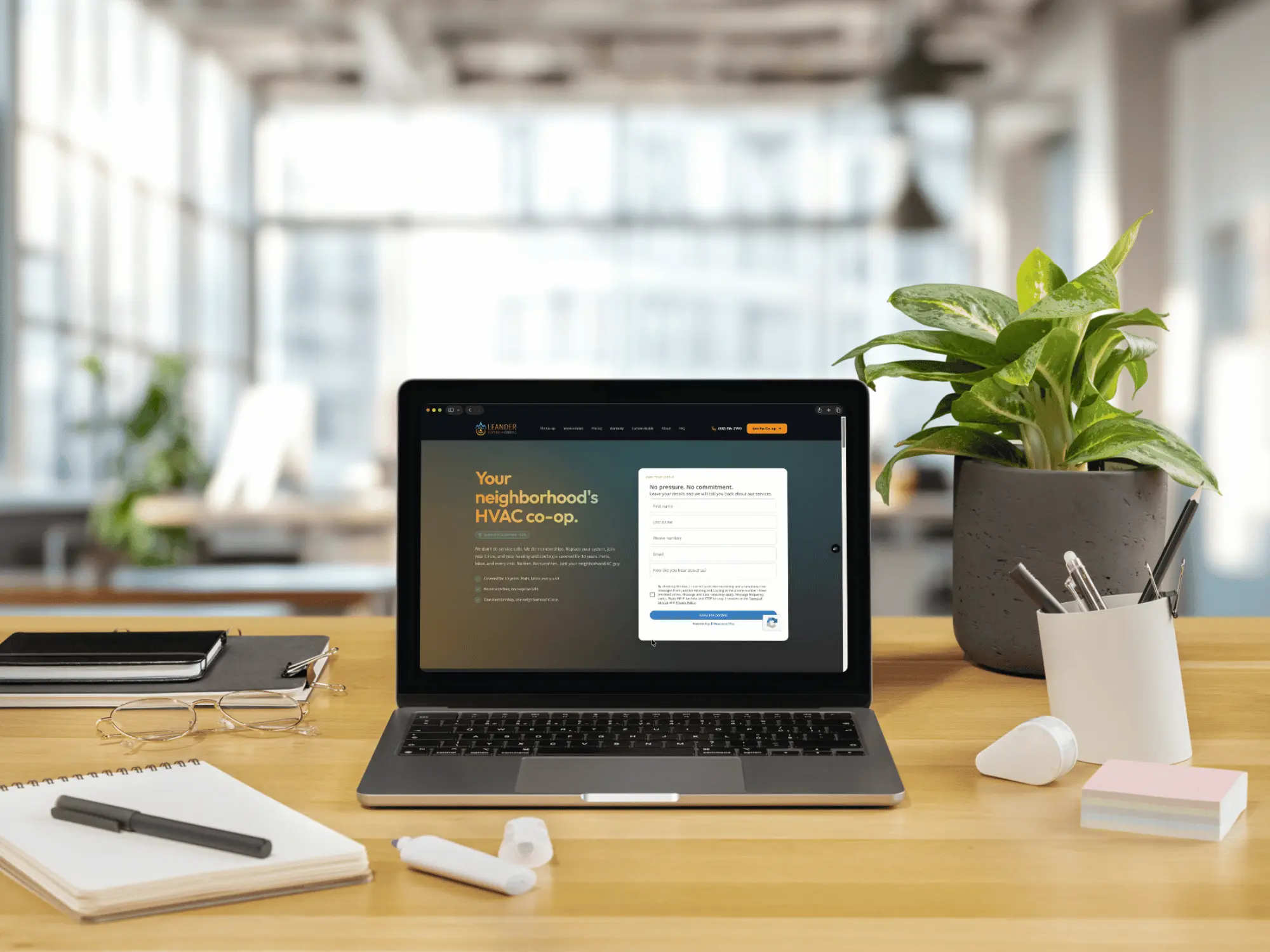 A custom small-business website open on a laptop on a bright, styled desk
